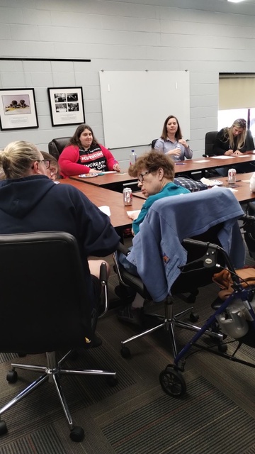 Group of people seated at connected tables